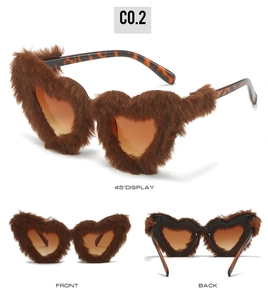 Detail view of heart-shaped sunglasses with brown faux fur trim and tortoiseshell temples
