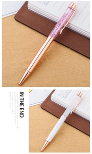 Detail of creative metal ballpoint pens with liquid glitter sand and 24k gold leaf decor