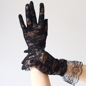 Close-up of black lace gloves with floral embroidery and elegant wavy scalloped wrist cuffs