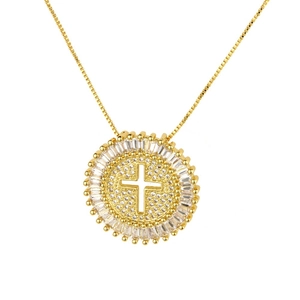 Detailed close-up of a gold-plated cross pendant with circular micro-paved cubic zirconia