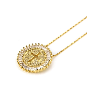 Macro detail of gold cross pendant necklace featuring brilliant pavé-set crystals