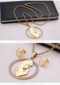Macro detail of gold-plated twisted chain necklace and rhinestone praying silhouette charms