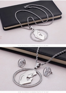 Macro detail of silver religious necklace set with rhinestone pendant and rope chain