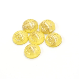 Detailed view of 12mm yellow synthetic opal resin cabochons with gold foil flakes