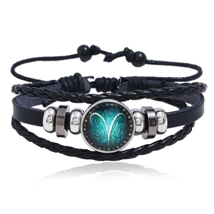 Detail view of multi-layer Aries leather bracelet with luminous green glass charm