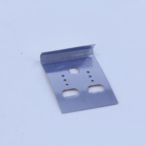 Detail view of L-shaped silver metal stamping bracket with precision mounting holes