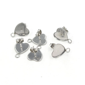 Detailed view of six silver stainless steel heart-shaped stud earring bases with loops