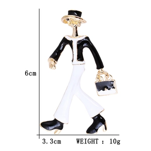 Modern enamel brooch of a lady in black and white dress with gold trim and dimensions