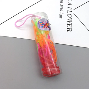 Macro view of multi-color disposable hair elastics in a portable tube with a butterfly tag