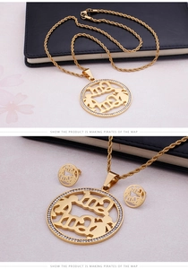 Detail of gold MAMA jewelry set featuring a zircon studded pendant and matching earrings
