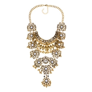 Detailed macro of vintage bohemian layered gold choker necklace with ethnic tassels