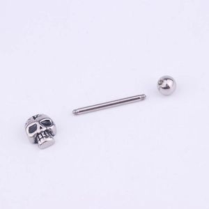 Stainless steel skull tongue stud with black enamel eyes on a clean white background