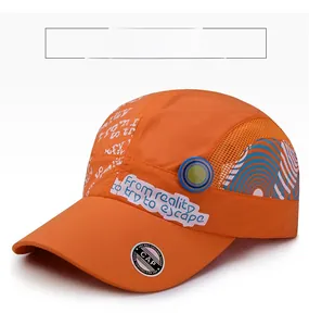 Detail of orange quick-dry baseball cap featuring mesh panels and artistic text graffiti