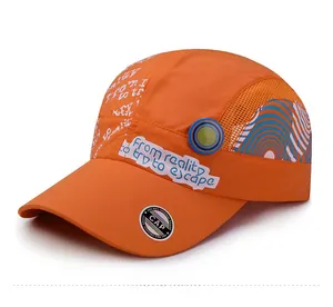 Macro shot of breathable orange quick-dry cap with mesh panels and graphic prints