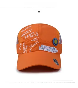 Close-up of orange quick-dry sun hat with white graffiti print and breathable side mesh