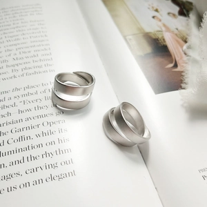 Detailed view of matte brushed S925 sterling silver rings with elegant layered design