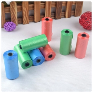 Bulk colorful rolls of lightweight biodegradable pet waste bags on a mesh surface