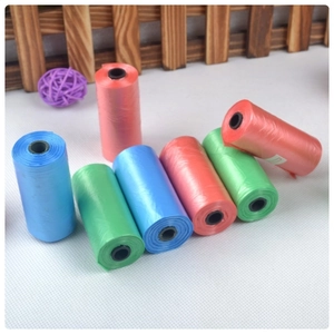 Detail of multi-colored biodegradable pet waste bag rolls in blue, green and pink colors