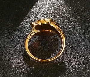 Macro view of gold ring with intricate snakeskin texture against a dark luxury background