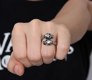 Close-up of retro silver skull ring with detailed scale texture and gothic punk design