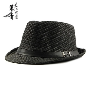 Close-up of black straw fedora showing fine woven texture and leather belt with metal buckle