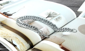 Detail of a bold titanium steel chain link bracelet with a secure lobster clasp