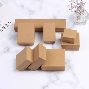 Set of multi-size vintage kraft paper jewelry gift boxes on white marble background