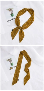 Close-up of mustard yellow silk scarf with geometric pattern for hair or bag