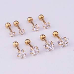 Detailed set of four pairs of gold stainless steel star earrings with clear zircon stones