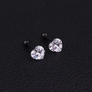 Macro detail of heart-shaped zircon earrings with black stainless steel screw ball back