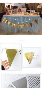 Close-up of gold and striped paper pennants for birthday party banners and festive decor