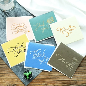 Close-up of assorted Thank You cards in multiple colors with elegant gold foil printing