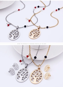 Detail of tree of life jewelry sets in gold and silver with crystal beads on a tray