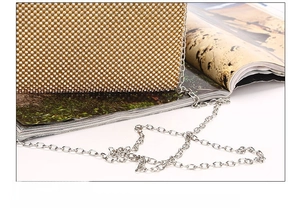 Close-up of durable gold rhinestone evening bag with polished silver chain and metal frame