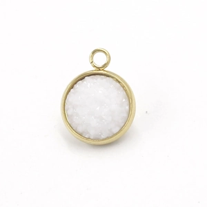 Close-up of circular stainless steel gold pendant with white resin druzy texture inlay