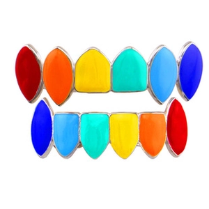 Detailed macro view of rainbow colored vampire grillz set with shiny colorful enamel finish