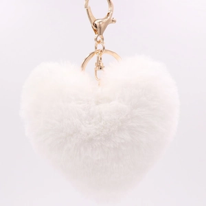 Close-up of white plush heart-shaped keychain with gold metal clasp on white background