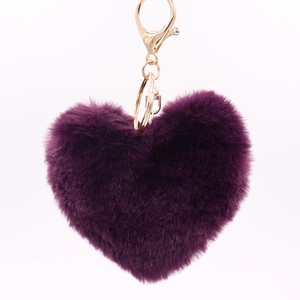Close-up of heart-shaped dark purple faux fur keychain with gold-plated metal clasp