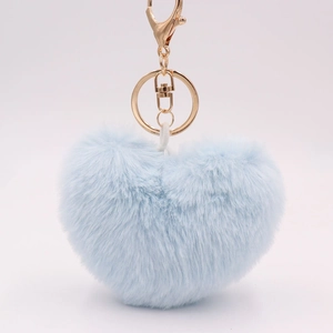 Detailed view of light blue heart-shaped plush keychain with gold metal hardware