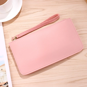 Pink lychee texture long leather wallet with gold zipper and wristlet on wood table