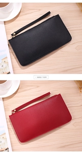 Detail view of red and black lychee grain leather clutches with detachable wrist straps