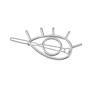 Close-up of a silver metal eye-shaped hair clip with minimalist detail on white background