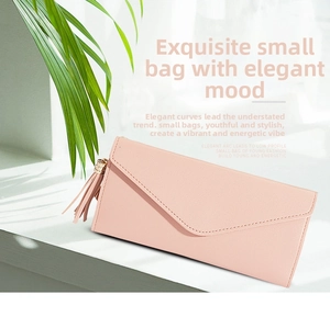 Pink long wallet with lychee texture featuring a stylish leather tassel and heart charm