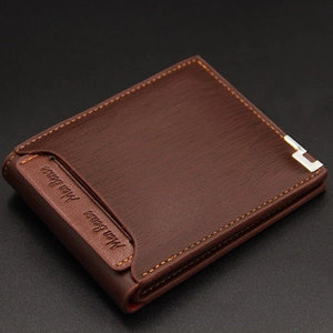 Detail of men's brown wallet with brushed texture, orange stitching and metal accent