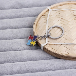 Four-color puzzle piece friendship keychain set in red, blue, and yellow finish