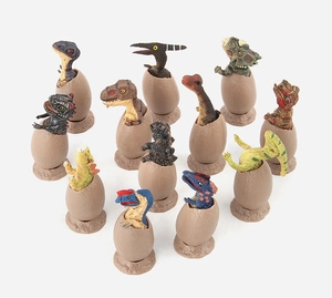 Top view of 12 detailed dinosaur hatchling models inside cracked eggs on white background