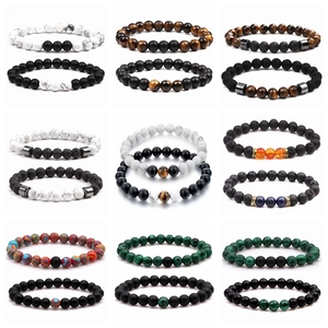 Detailed collection of volcanic stone and turquoise beaded bracelets with crown metal accents
