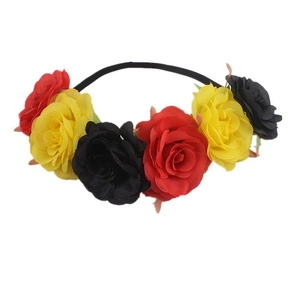 Detail view of artificial roses in red, yellow and black on a slim headband crown