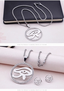 Detail of round Eye of Horus necklace and earrings set with crystal inlay in gold finish
