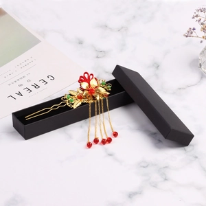 Traditional Chinese gold hairpin with red floral detail and tassels in a black gift box